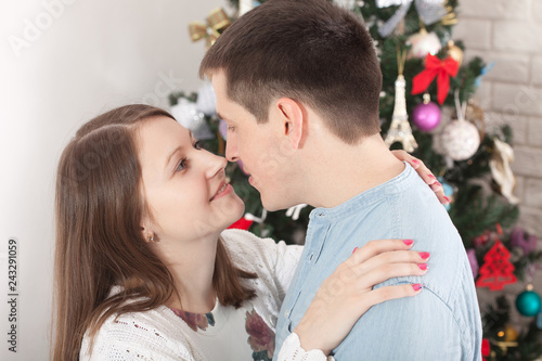 Couple hugging in Christmas time at home