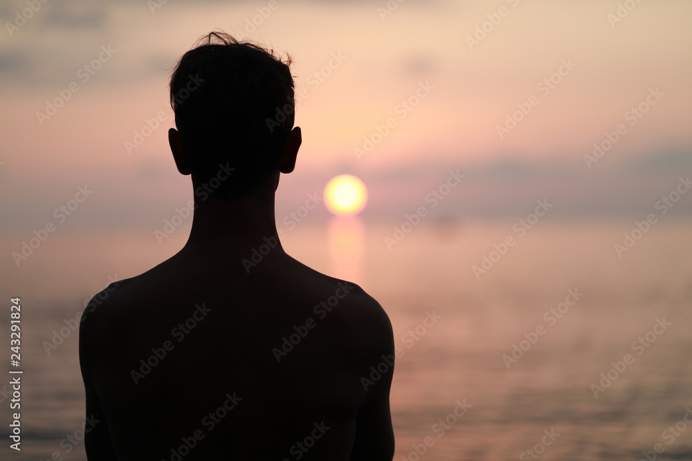 Men silhouette at sunset on the sea