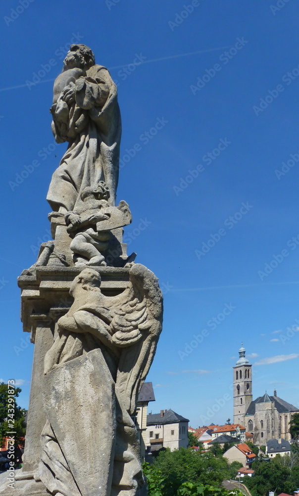 Obraz premium Statue on the bridge that connects Jesuit College and Saint Barbara church, Kutna Hora, Czech republic