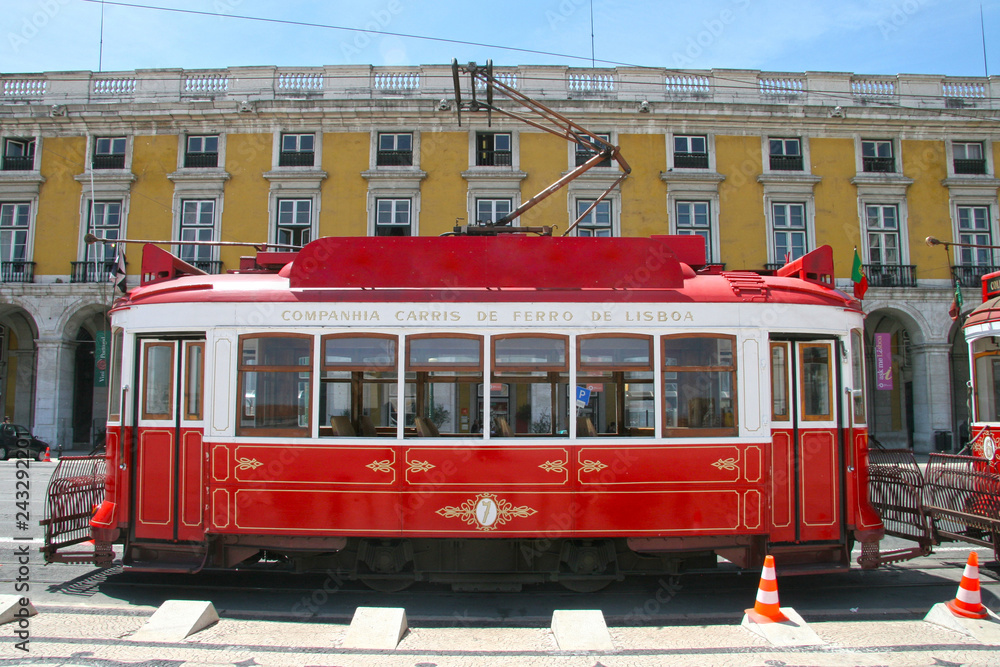 Traditional red tram in Praça do Comércio (or Commerce Square), Lisbon, Portugal.