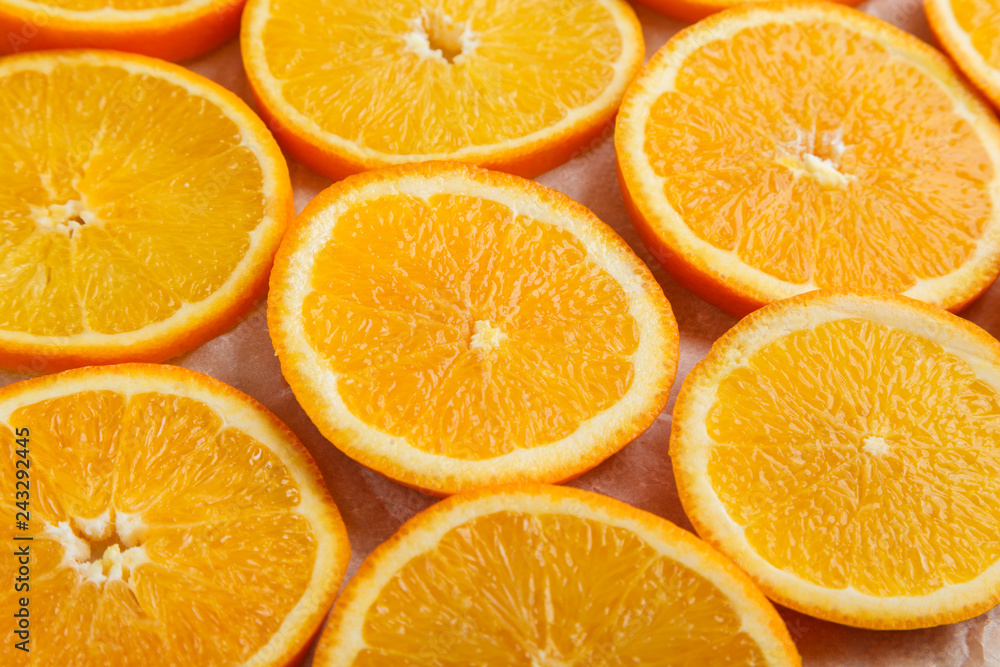 Abstract background with citrus orange slices on parchment paper. Close up. Top view. Studio photography. Abstract background with citrus orange slices on parchment paper. Close up. Top view. Studio photography.
