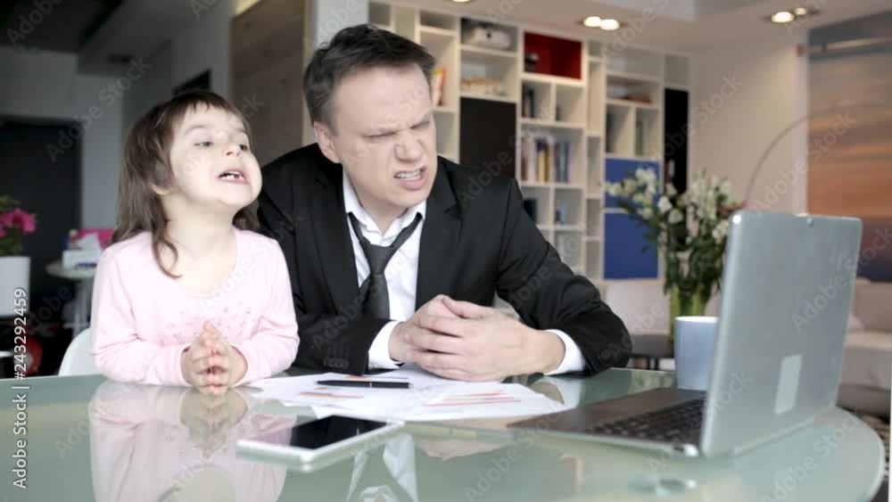 Businessman works from home and takes care of his little daughter Businessman works from home and takes care of his little daughter