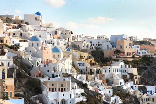 Oia town with tradional buildings painted white on the cliffside, Santorini, Cyclades, Greece.