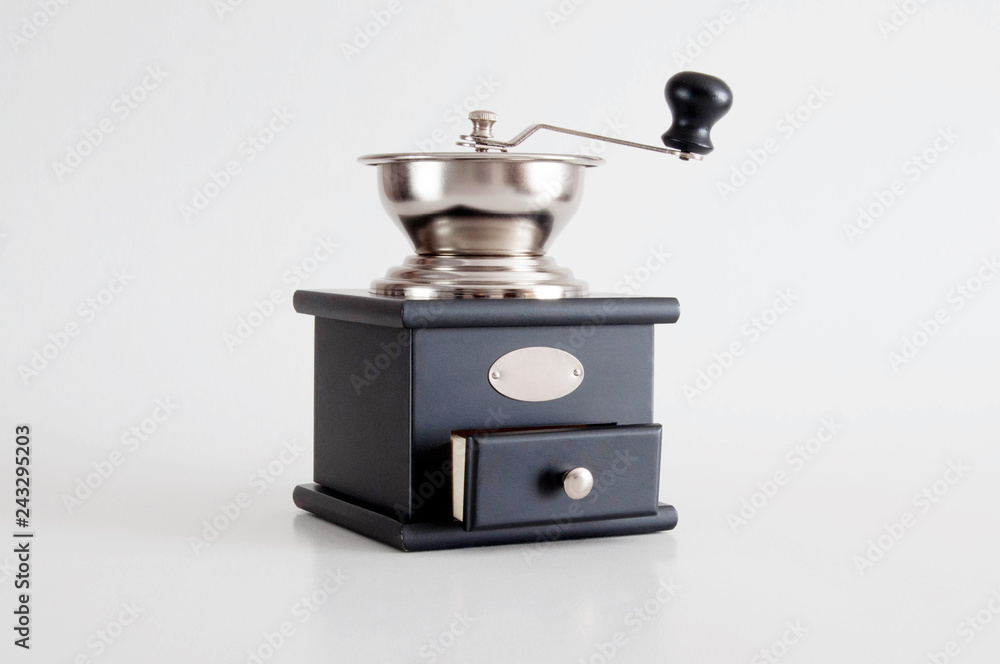 Black manual coffee grinder for coffee beans on white background Black manual coffee grinder for coffee beans on white background