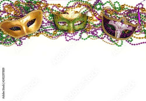 Festive Carnival background with masks, beads and copy space.