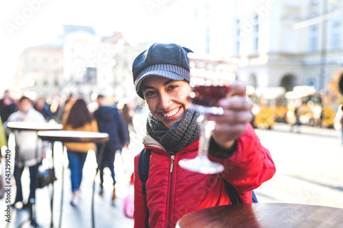 Woman holding a glass of red wine.