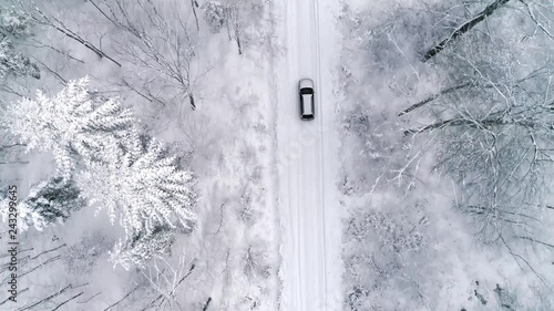 Aerial view of car on road in winter forest