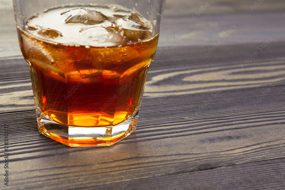whiskey with ice cubes on wooden background whiskey with ice cubes on wooden background