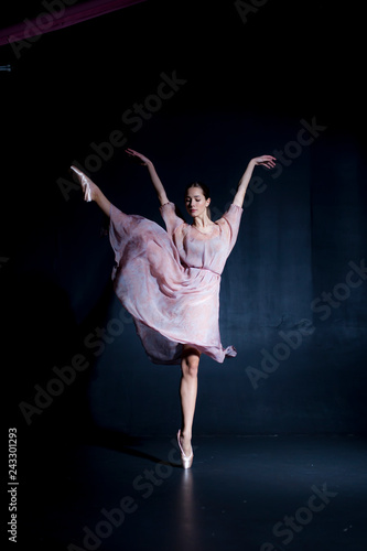 Graceful ballerina dancing on a black background