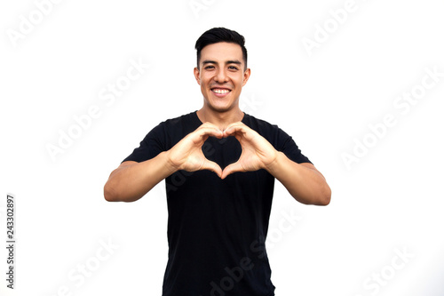 Handsome latin hispanic man making heart with his hands.