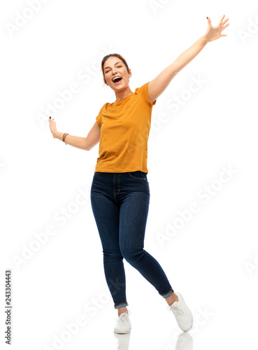 emotions and people concept - happy young woman or teenage girl in blank orange t-shirt having fun over white background