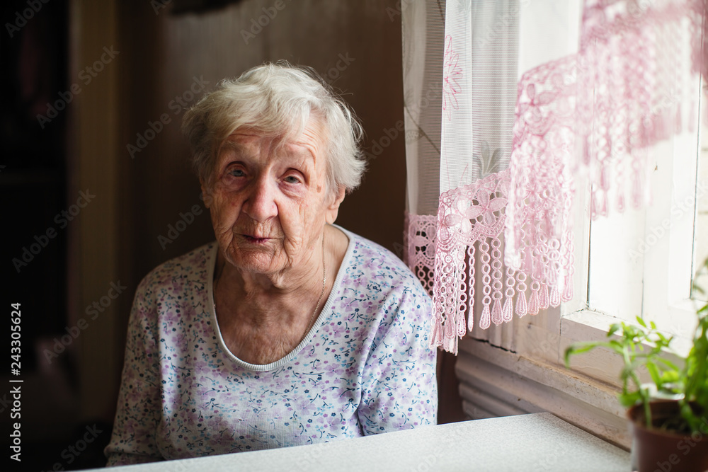 Elderly russian woman sitting at table. Elderly russian woman sitting at table.