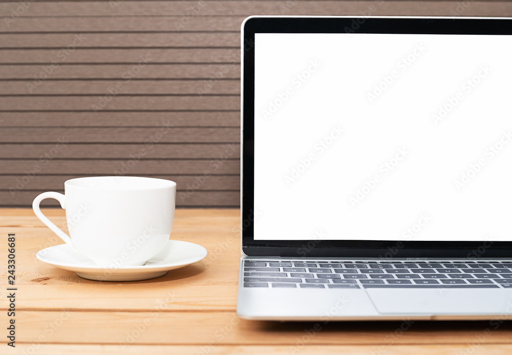 Coffee cup with laptop mockup on wood Coffee cup with laptop mockup on wood
