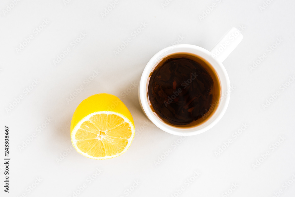 Mug of hot tea with lemon on gray background. Catarrhal disease. Flu season. Mug of hot tea with lemon on gray background. Catarrhal disease. Flu season.