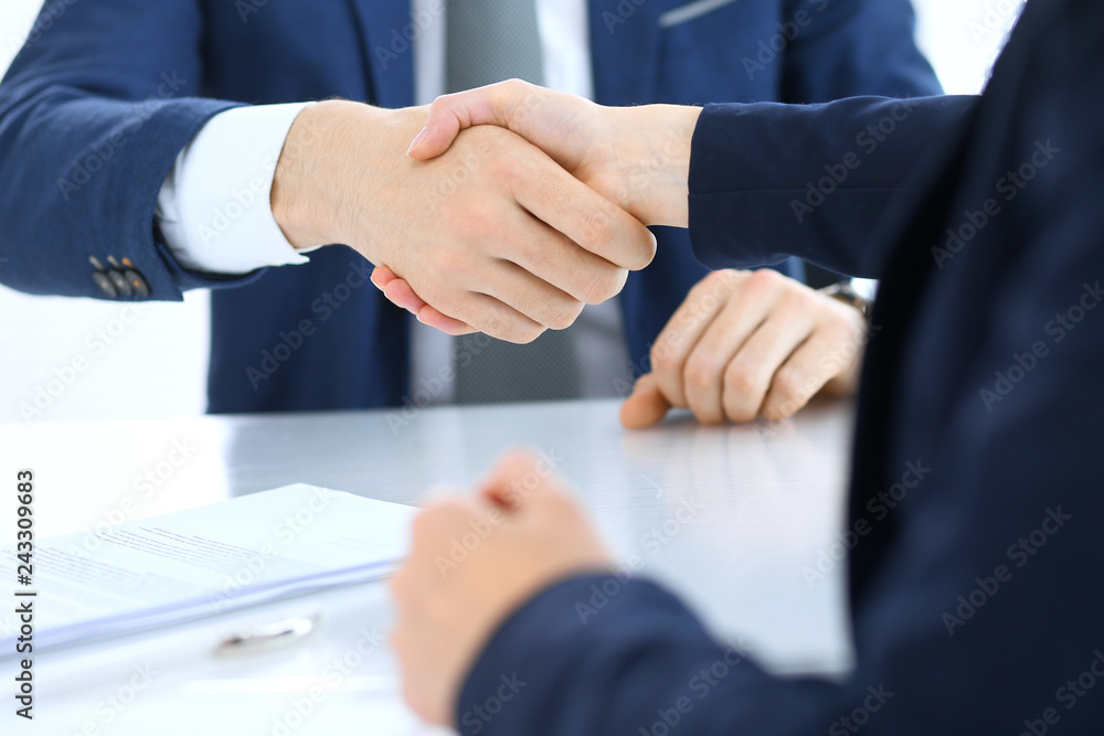 Obraz premium Group of business people or lawyers shaking hands finishing up a meeting , close-up. Success at negotiation and handshake concepts