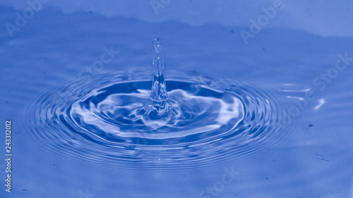 water drops hits on water surface creates water waves