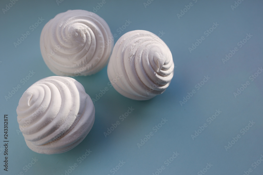 White marshmallows on blue background. Flat lay, copy space White marshmallows on blue background. Flat lay, copy space