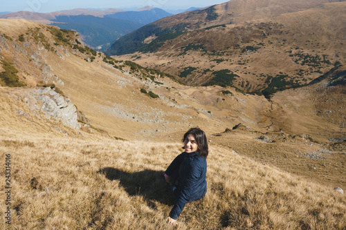 smiling woman on top of transalpina hill photo