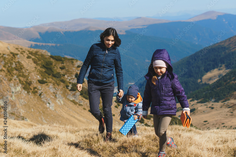 woman walking with son and daughter in transalpina