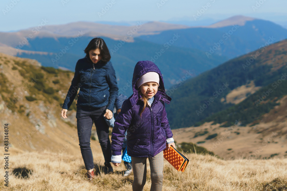girl and mother with brother walking in transalpina