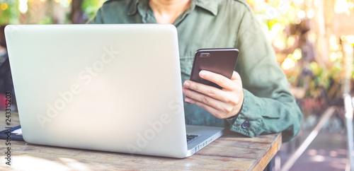 Business women working with computer laptop and smartphone is holding hand. Online shopping concept. Workplace at home office. Web banner