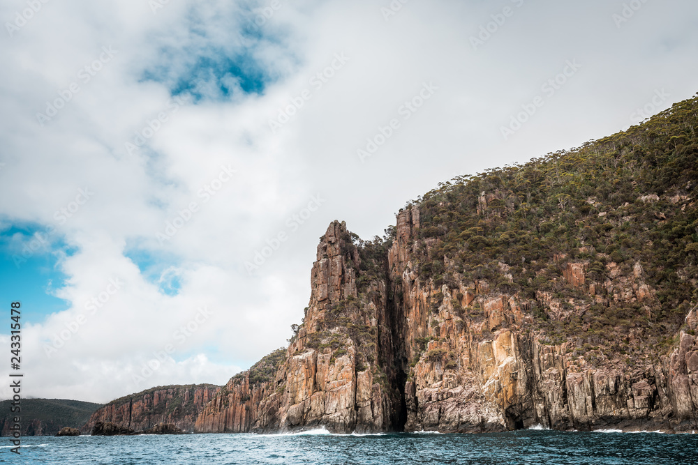 cliffs of the tasman peninsula on tasmania island, amazing coastline the highest rock cliffs in australia and the southern hemisphere , spectacular boat cruise on the rough atlantic ocean