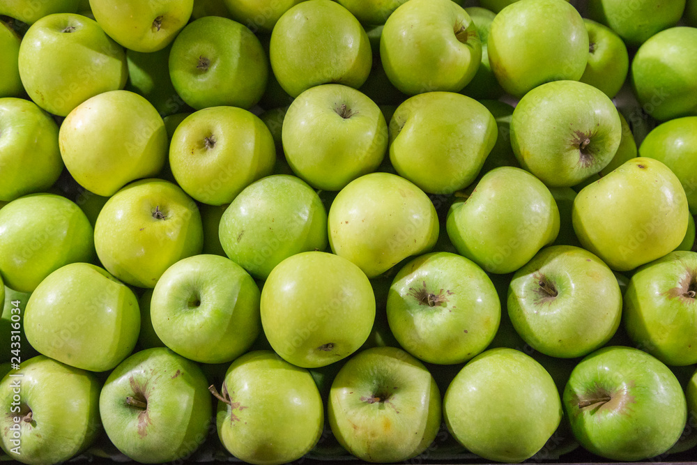 Green apple pile put together looking from the top view at market Green apple pile put together looking from the top view at market