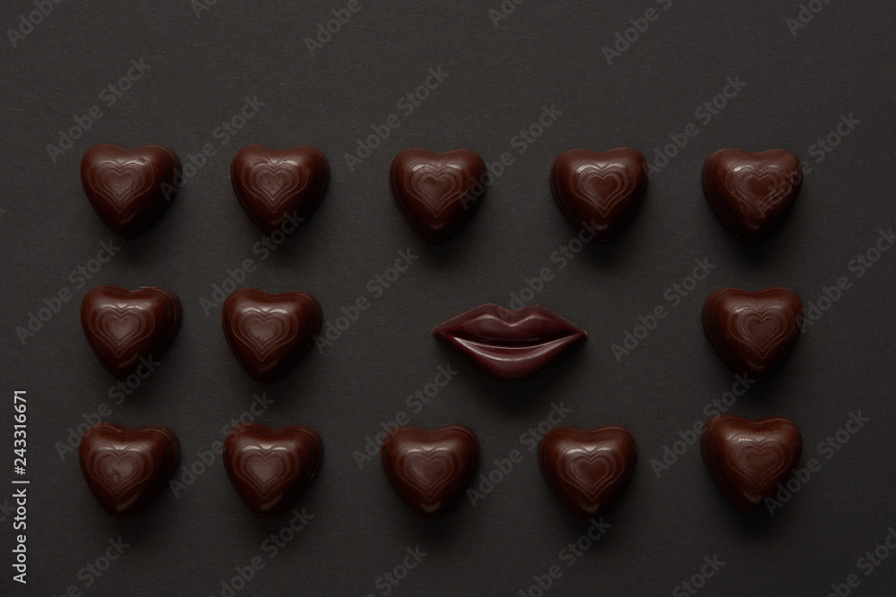 top view of tasty chocolate lips and chocolate hearts on black background top view of tasty chocolate lips and chocolate hearts on black background