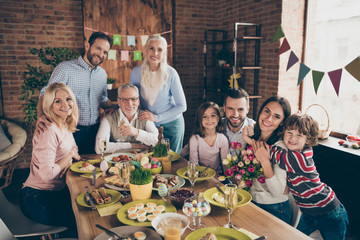 Close up photo of large company gathered family holiday sitting 