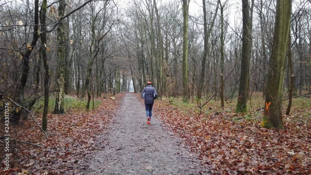 Senior runner on a forest track in the winter Senior runner on a forest track in the winter