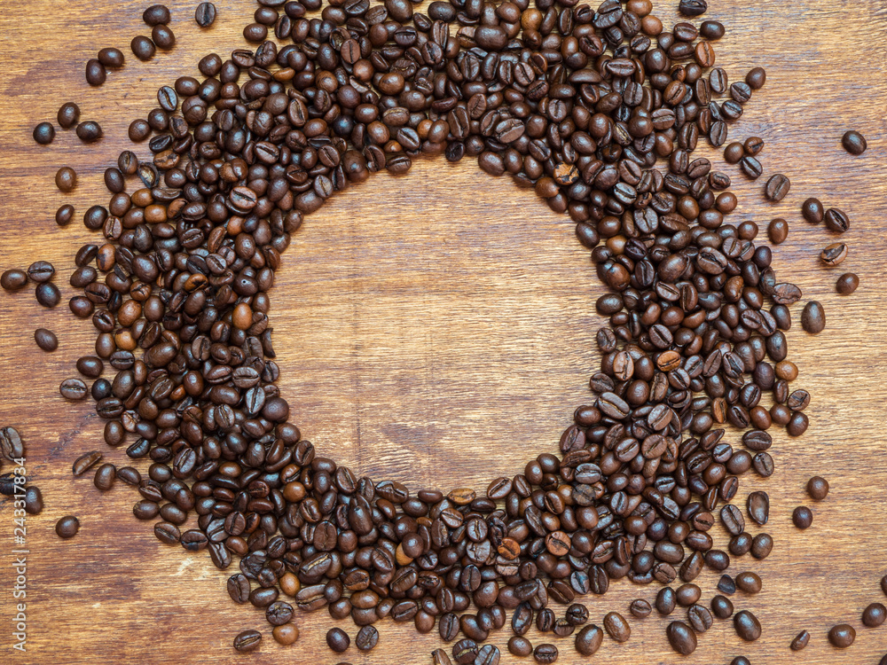 Espresso coffee beans scattered on wood background in circle. Copy space. Flat lay Espresso coffee beans scattered on wood background in circle. Copy space. Flat lay