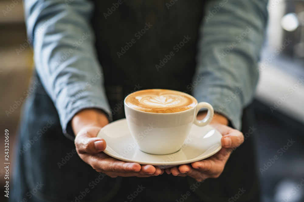 Latte art coffee in hands Latte art coffee in hands