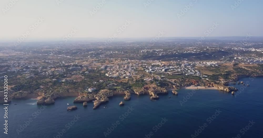Aerial view of beautiful natural beach in Algarve region of Portugal. Famous beach of southern Portugal resort from above. Summer vocation destination Aerial view of beautiful natural beach in Algarve region of Portugal. Famous beach of southern Portugal resort from above. Summer vocation destination