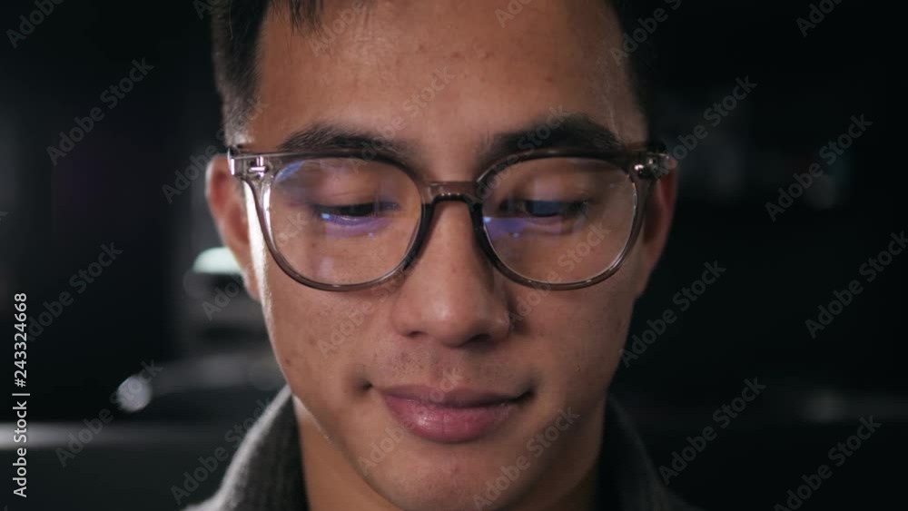 education, deadline and people concept - close up of creative man in glasses working at night office and thinking happy asian freelancer korean man laptop education, deadline and people concept - close up of creative man in glasses working at night office and thinking happy asian freelancer korean man laptop