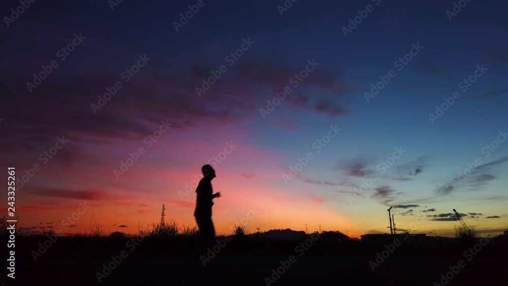 Silhouette of young man jogging in summer sunrise sky outdoor. Lifestyle healthy concept . Silhouette of young man jogging in summer sunrise sky outdoor. Lifestyle healthy concept .