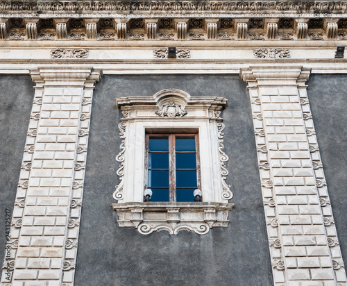 Upper part with an ancient window of the Palazzo del Seminario dei Chierici in Catania photo