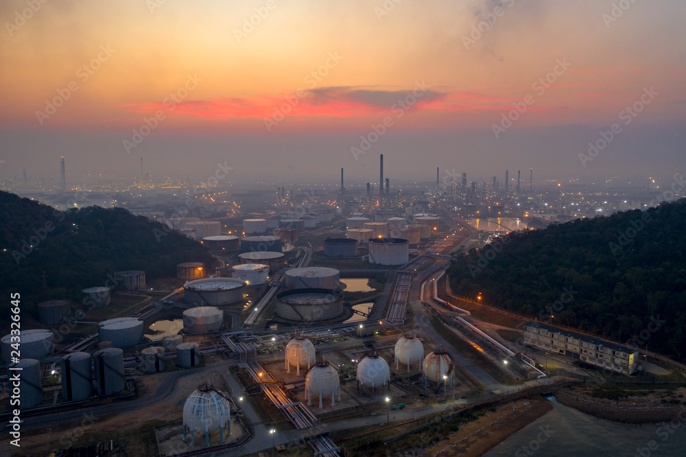 Fototapeta premium Aerial view. oil refinery factory and Oil industry at sunrise. Petrochemical Industrial.