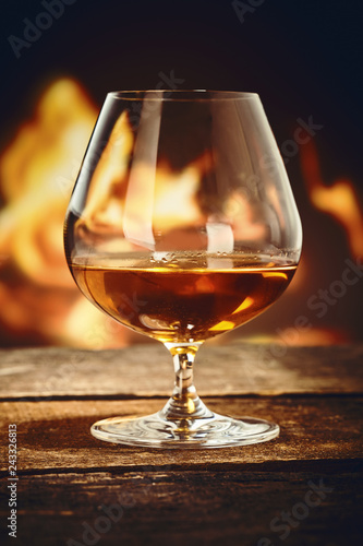 Snifter with French cognac in front of a fire