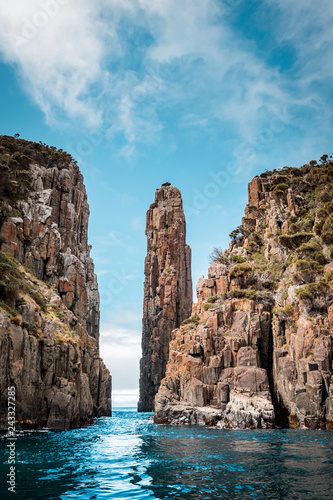 View to the Totem Pole of Cape Hauy, rough coastline with dolerite cliffs, Tasmania, Australia