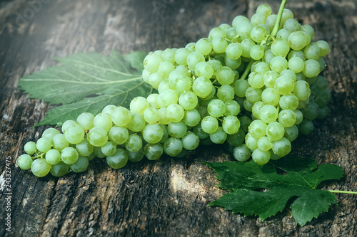 bunch of green grapes on wooden background