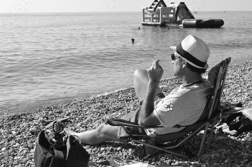 A man on the beach looking into the distance