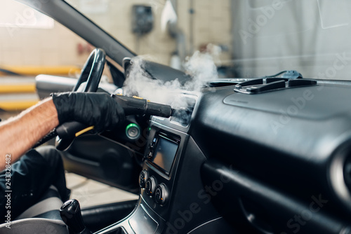 Carwash, removing dust and dirt with steam cleaner