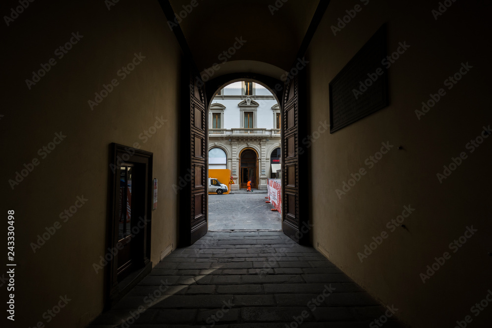 alley and big tall door of museum in florence