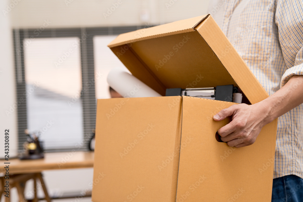 business man are stressed from being fired from work and holding brown cardboard box.unemploy or resign concept. business man are stressed from being fired from work and holding brown cardboard box.unemploy or resign concept.