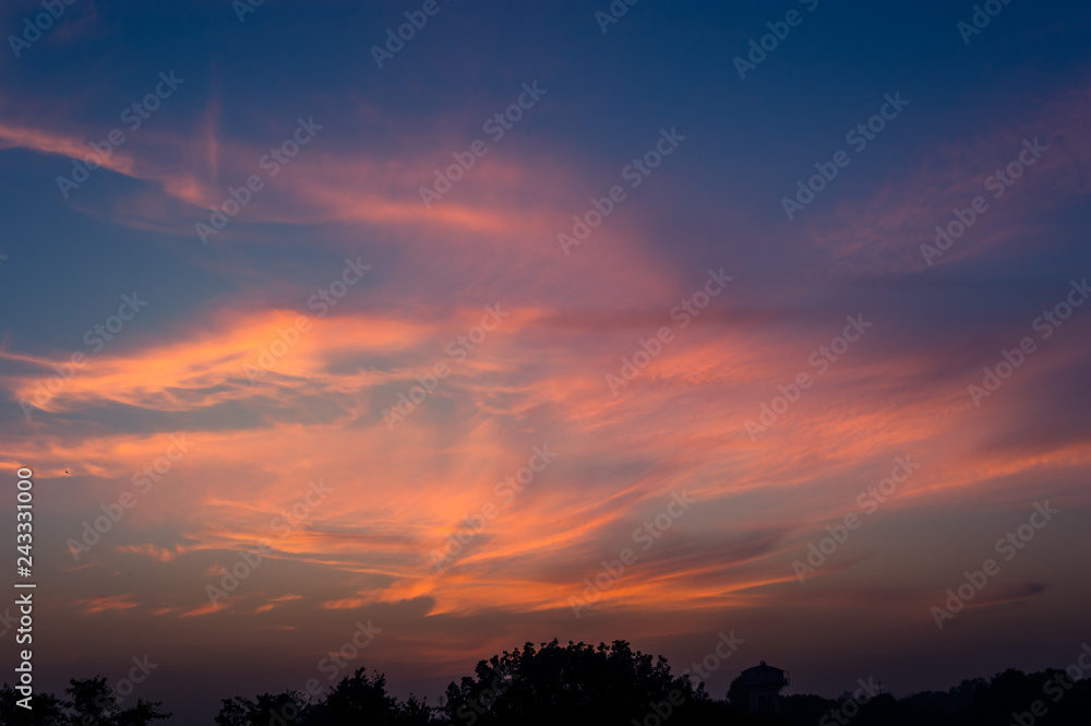 Sky with glowing clouds after sunset forming a dramatic and beautiful sky