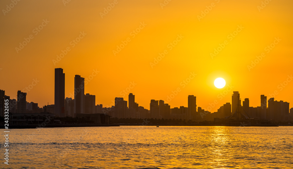 Skyline of Kuwait City at sunset.