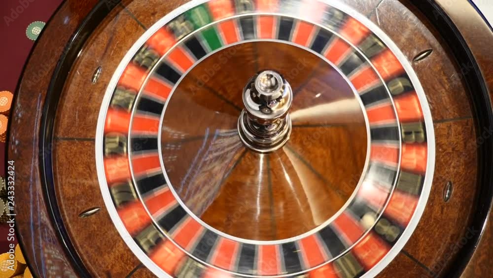 Casino concept. Top view on roulette in motion, white ball spinning. Bad luck and Good luck concept. Roulette wheel running. City nightlife entertainment. hd Casino concept. Top view on roulette in motion, white ball spinning. Bad luck and Good luck concept. Roulette wheel running. City nightlife entertainment. hd