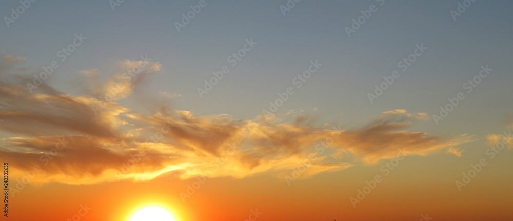 Beautiful golden fiery sunset background in the sky 