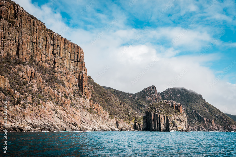 cliffs of the tasman peninsula on tasmania island, amazing coastline the highest rock cliffs in australia and the southern hemisphere , spectacular boat cruise on the rough atlantic ocean