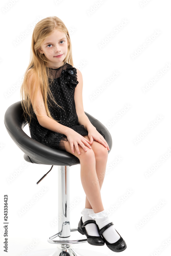 Little girl is sitting on a chair Little girl is sitting on a chair